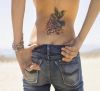 hummingbird pic tattoo on lower back of girl